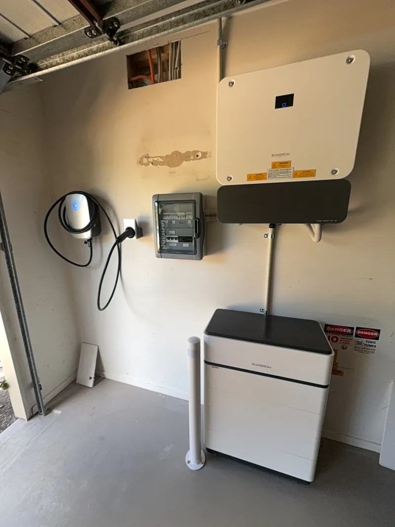 Garage install with solar inverter, battery storage and a wall-mounted EV charger