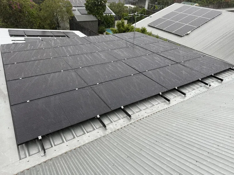 Black solar panel array installed on a corrugated tin roof in South East Queensland